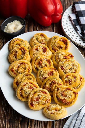 You'll LOVE these super Easy Pesto Crescent Pinwheels made with only 4 simple ingredients! Savory and delicious, this quick appetizer is perfect for any party or family gathering! #mustlovehomecooking