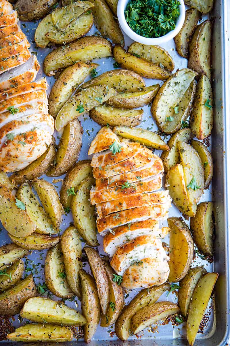 Easy Garlic Herb Chicken with Potatoes is deliciously herb spiced chicken breasts with crispy potato wedges made simple on a single sheet pan.