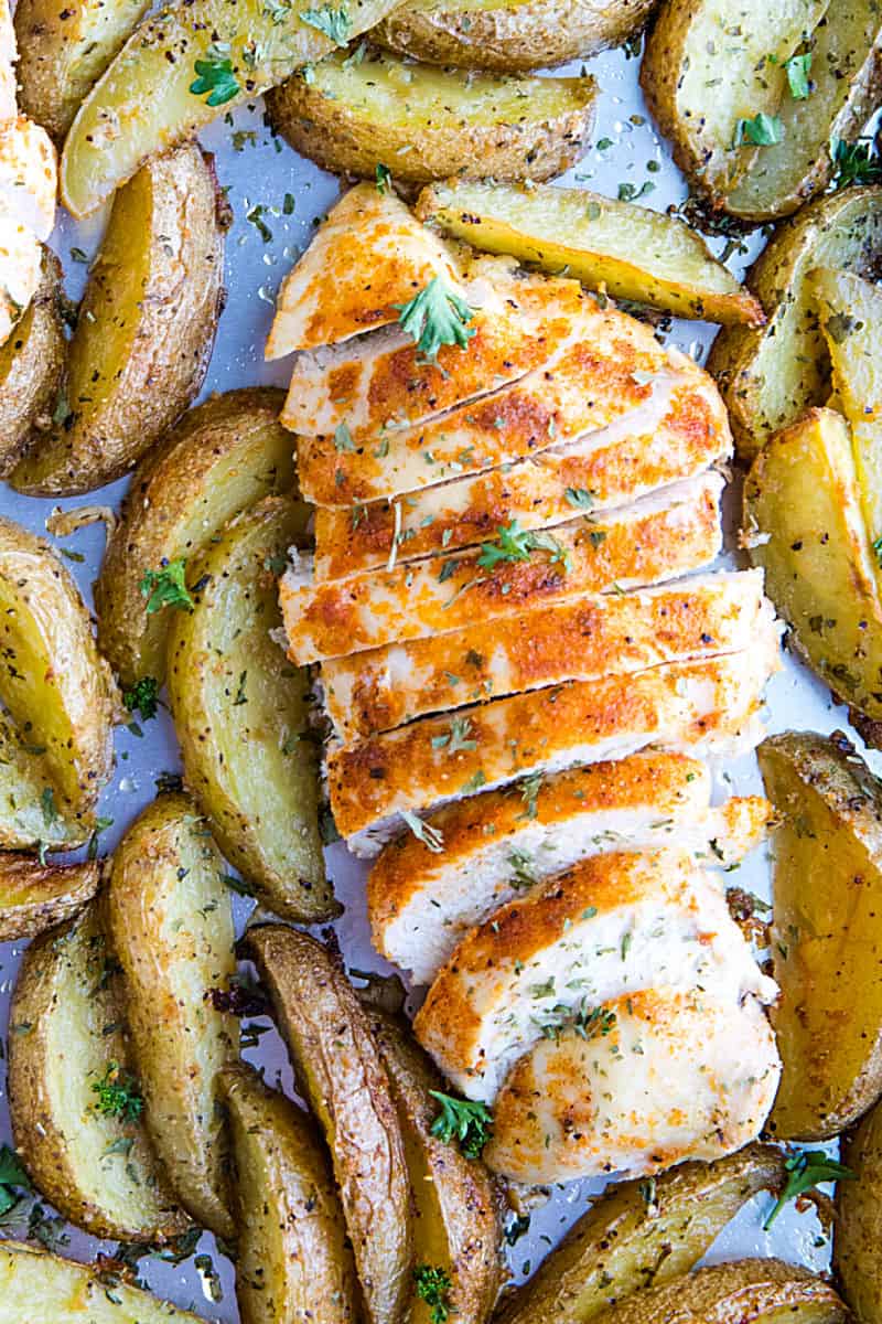 Easy Garlic Herb Chicken with Potatoes is deliciously herb spiced chicken breasts with crispy potato wedges made simple on a single sheet pan. #mustlovehomecooking #chickendinner #sheetpandinner #sheetpanchicken