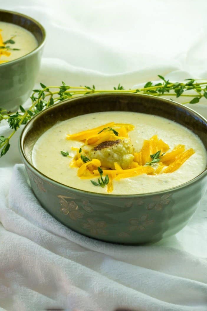 Cauliflower soup garnished with thyme leaves