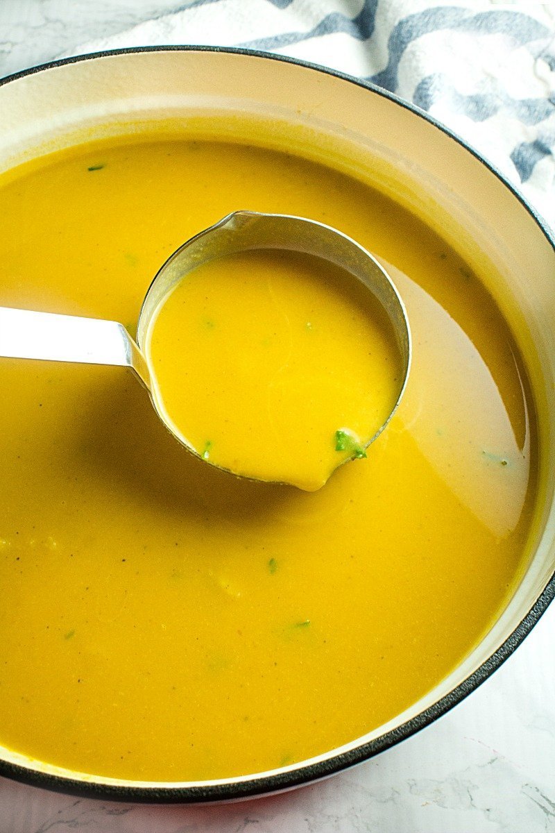 Pot of Roasted butternut squash soup on ladle